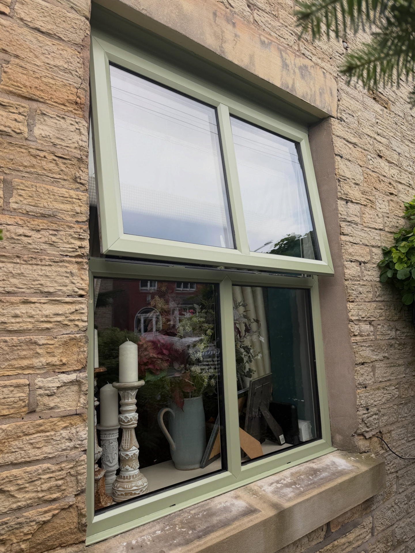 uPVC window frame resprayed in a soft sage green with a smooth even finish.